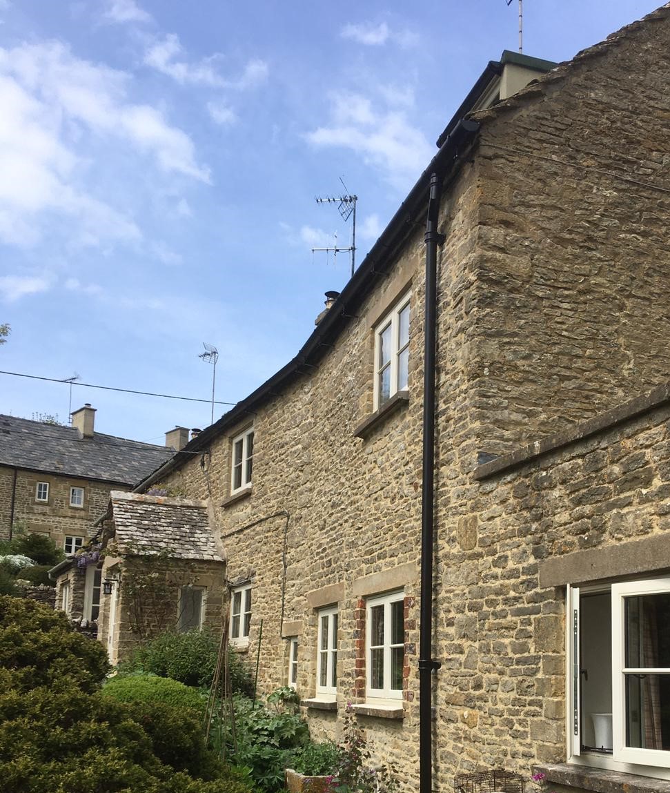 Aluminium gutter installation using rise and fall brackets on a heritage property near Burford