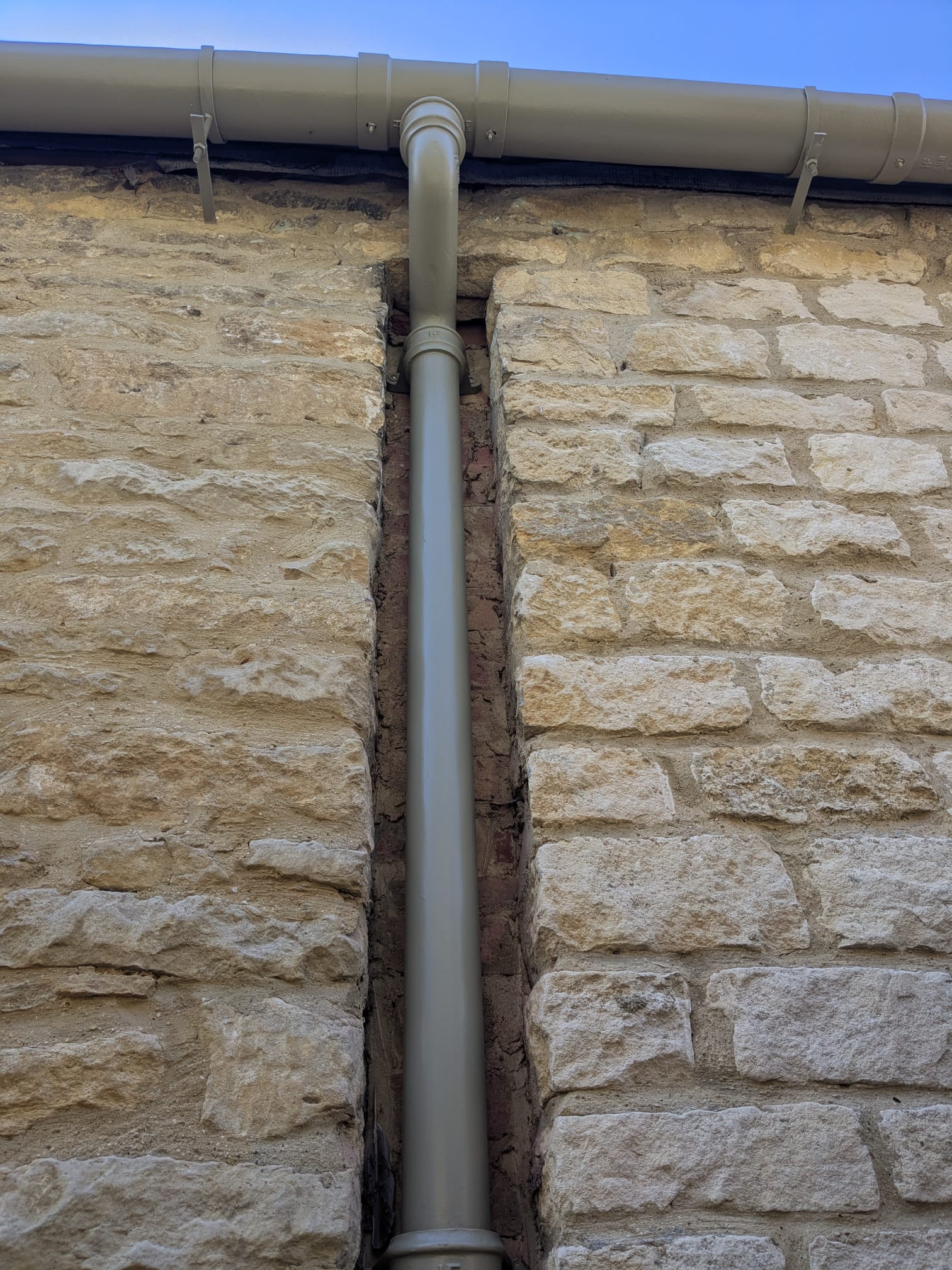 A Cast iron gutter and downpipe on a listed building in the centre of burford