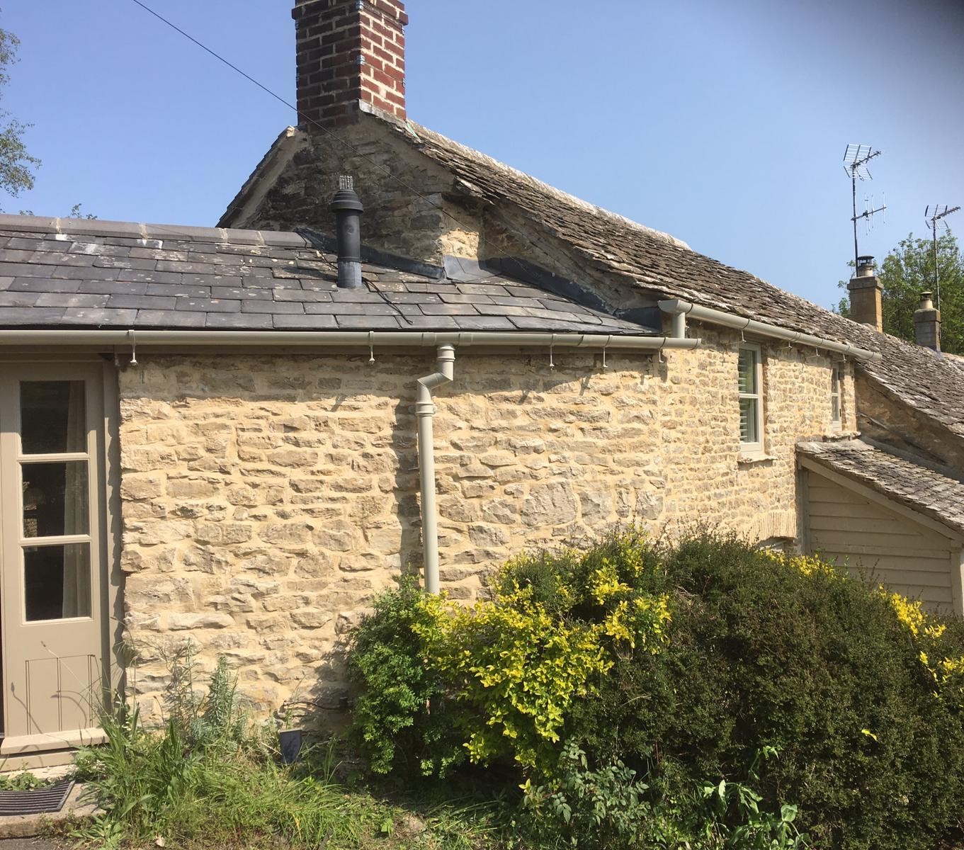 Aluminium cast iron style gutters and downpipe installed on a Cotswold stone property near burford 